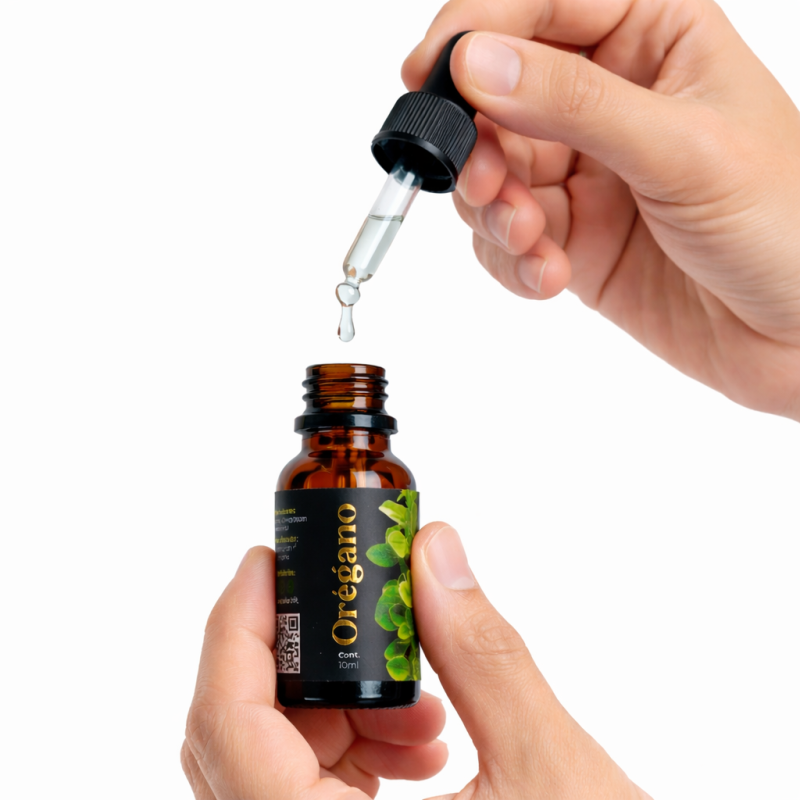 Gotero aplicando gotas transparentes en frasco de aceite de orégano Elyon Natural 10ml en Perú